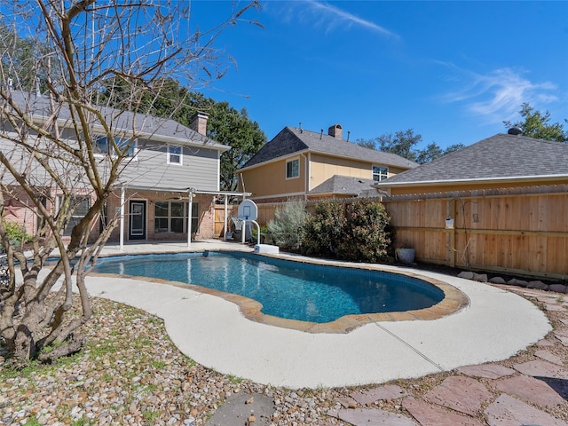 view of swimming pool featuring a fenced in pool, a fenced backyard, and a patio