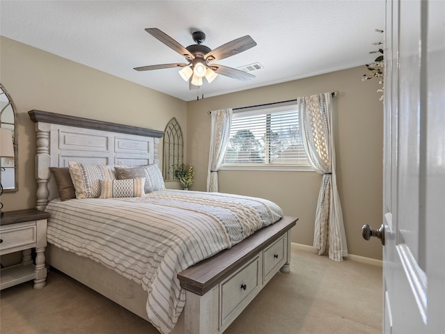 bedroom with light carpet, baseboards, visible vents, and a ceiling fan