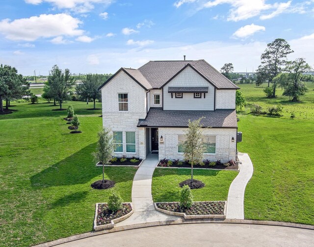 14811 Surfbird Ln, Houston, TX 77049 - view of front of home with stone siding, a front lawn, and roof with shingles