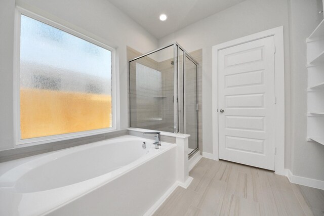 14811 Surfbird Ln, Houston, TX 77049 - full bathroom with a shower stall, a bath, and baseboards