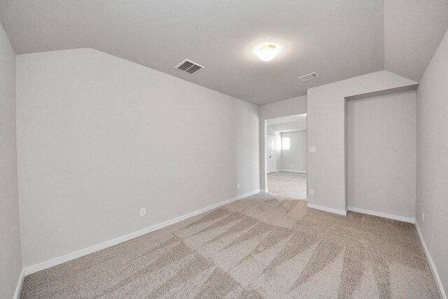 14811 Surfbird Ln, Houston, TX 77049 - unfurnished room with visible vents, light carpet, and vaulted ceiling