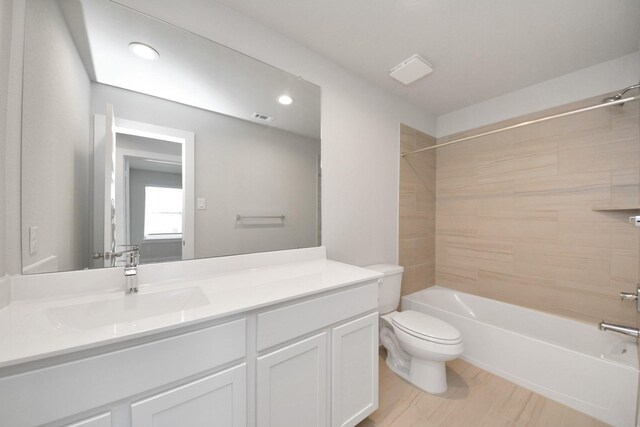 14811 Surfbird Ln, Houston, TX 77049 - bathroom with visible vents, toilet, wood finished floors, shower / bathing tub combination, and vanity