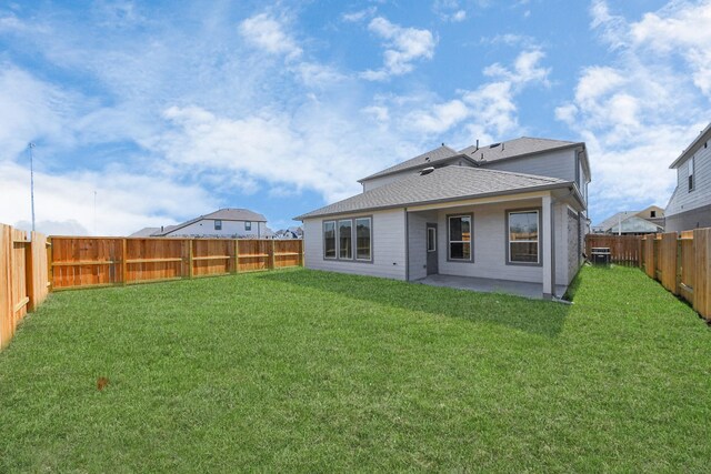 14811 Surfbird Ln, Houston, TX 77049 - rear view of property featuring a patio, a yard, a fenced backyard, central AC, and a shingled roof