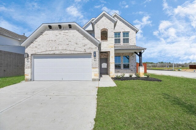 14811 Surfbird Ln, Houston, TX 77049 - view of front of property with driveway, stone siding, a front yard, a garage, and brick siding