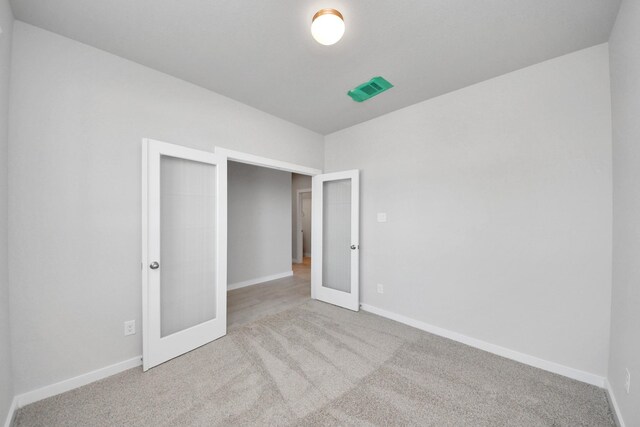 14811 Surfbird Ln, Houston, TX 77049 - unfurnished bedroom with french doors, baseboards, visible vents, and carpet flooring