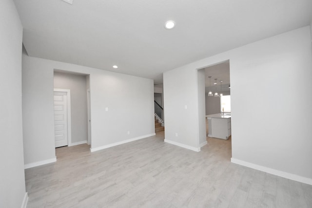 14811 Surfbird Ln, Houston, TX 77049 - unfurnished room featuring recessed lighting, stairway, baseboards, and light wood finished floors