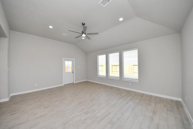 14811 Surfbird Ln, Houston, TX 77049 - empty room with light wood-type flooring, visible vents, baseboards, and vaulted ceiling