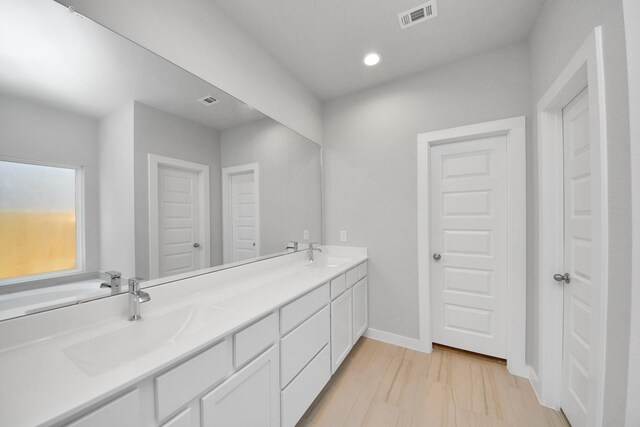 14811 Surfbird Ln, Houston, TX 77049 - bathroom featuring a sink, visible vents, baseboards, and double vanity