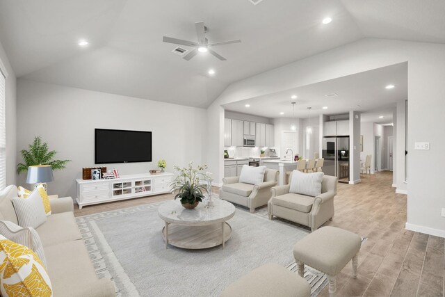 14811 Surfbird Ln, Houston, TX 77049 - living room with baseboards, visible vents, recessed lighting, vaulted ceiling, and light wood-type flooring