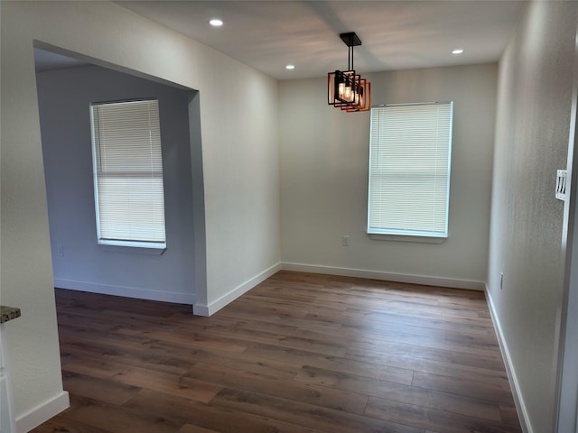 spare room with dark wood-style floors, recessed lighting, and baseboards