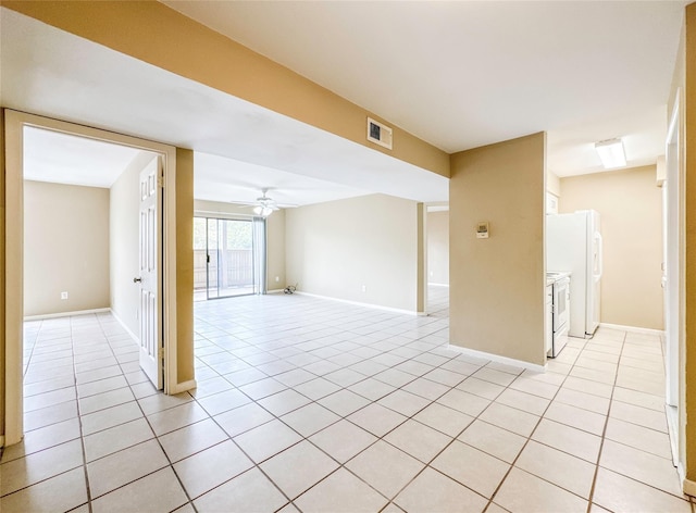 unfurnished room with ceiling fan, visible vents, baseboards, and light tile patterned flooring