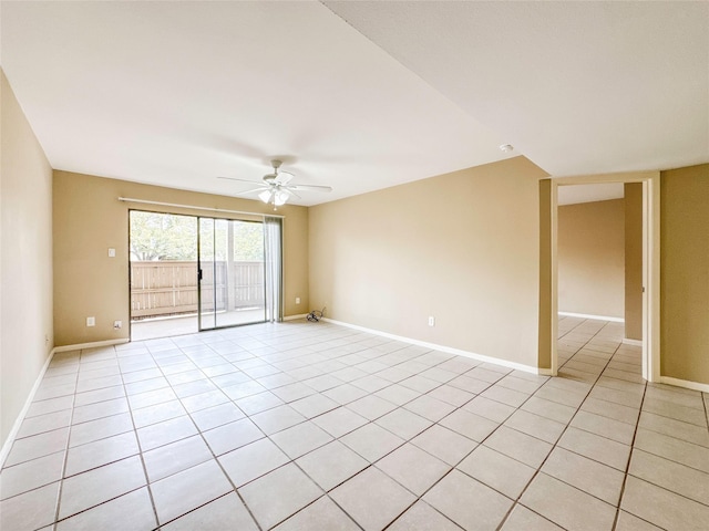 empty room featuring light tile patterned floors, ceiling fan, and baseboards