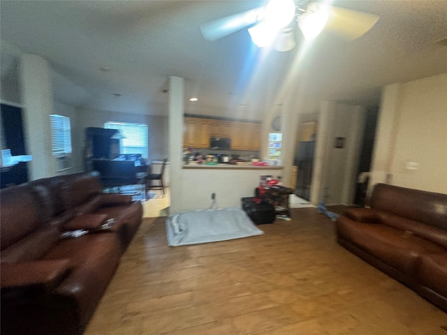 living room with light wood-style floors and ceiling fan