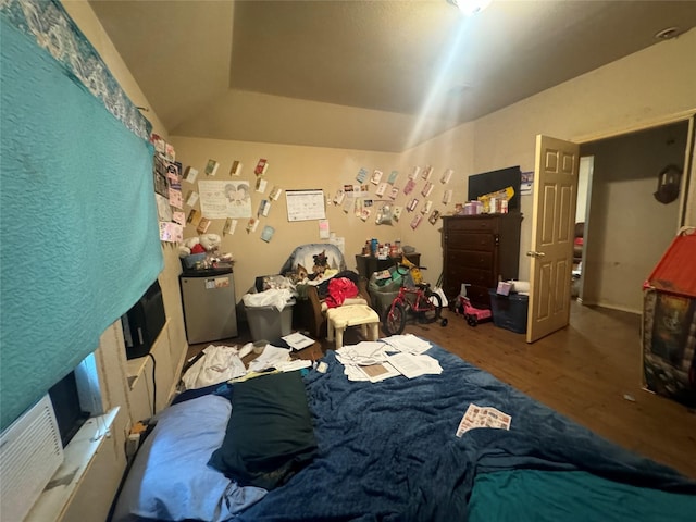 bedroom featuring fridge and wood finished floors