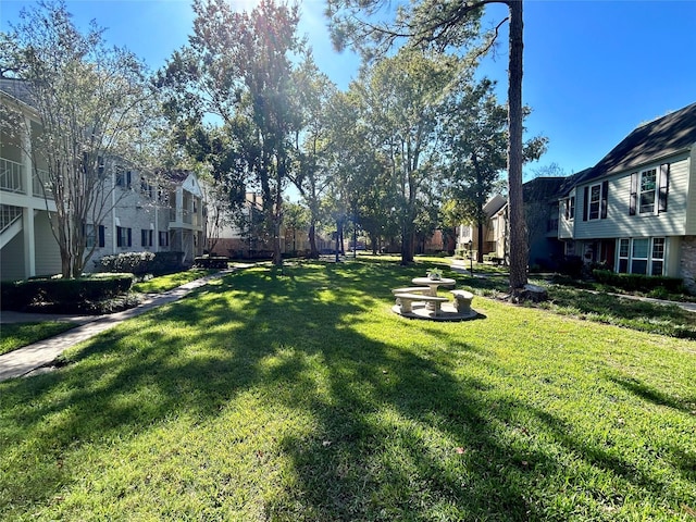 view of home's community featuring a yard and a residential view