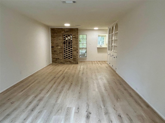 empty room with visible vents and wood finished floors