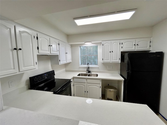 kitchen with black appliances, light countertops, a sink, and white cabinetry