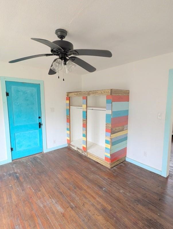 spare room featuring hardwood / wood-style flooring and baseboards