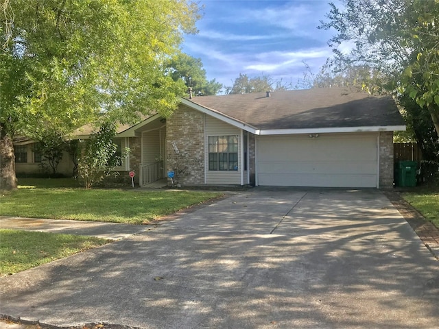 view of front of home featuring an attached garage, a front lawn, concrete driveway, and brick siding