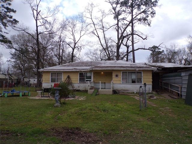 view of front of house featuring a trampoline and a front yard