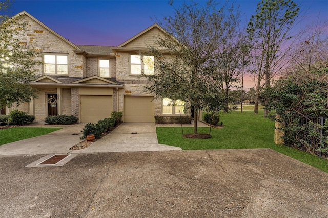 multi unit property featuring brick siding, an attached garage, concrete driveway, and a yard