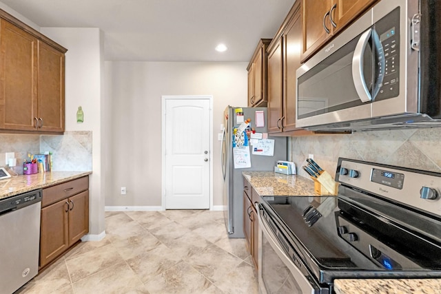 kitchen with decorative backsplash, brown cabinetry, and appliances with stainless steel finishes