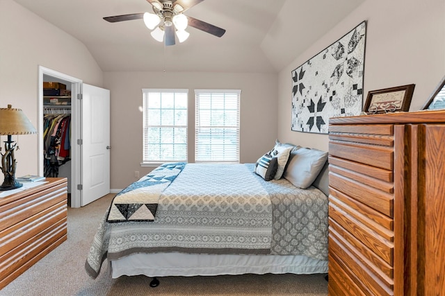 bedroom with carpet, ceiling fan, vaulted ceiling, a closet, and a walk in closet