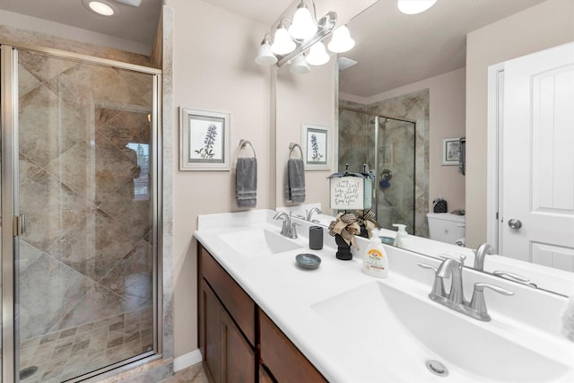 full bathroom featuring double vanity, a stall shower, and a sink