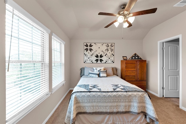 bedroom featuring a ceiling fan, baseboards, visible vents, carpet floors, and lofted ceiling