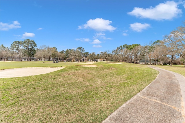 view of property's community with a lawn