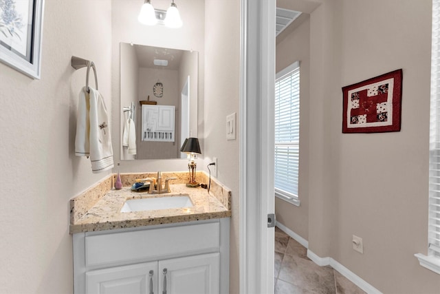 bathroom featuring vanity, tile patterned floors, and baseboards