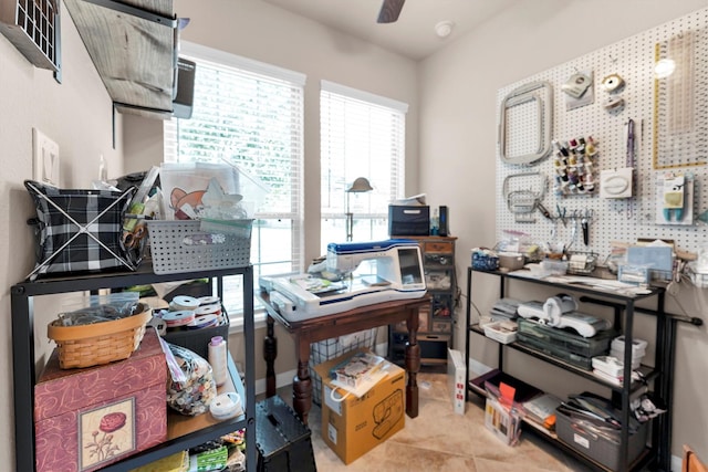 tiled office featuring a ceiling fan and baseboards