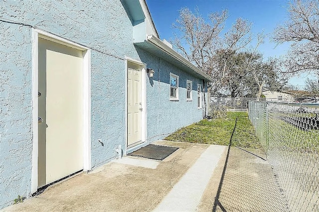 view of home's exterior featuring fence and stucco siding