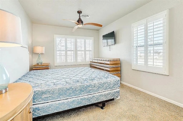 bedroom featuring ceiling fan, carpet, visible vents, and baseboards