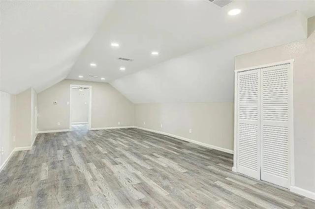 bonus room with recessed lighting, visible vents, vaulted ceiling, wood finished floors, and baseboards