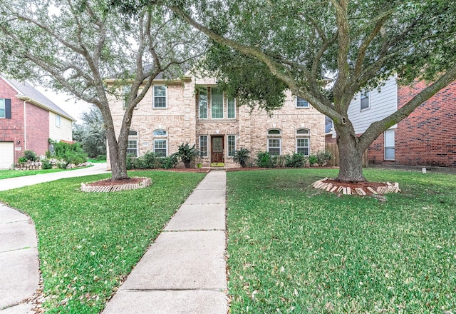 view of front of house featuring brick siding and a front yard