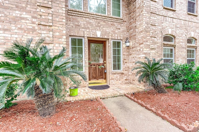 property entrance featuring brick siding