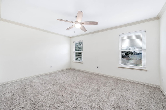 carpeted empty room featuring ornamental molding, a wealth of natural light, and baseboards