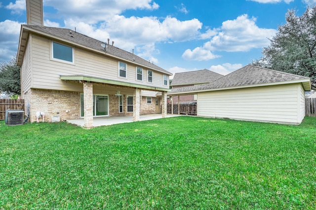 back of house with a patio area, fence, brick siding, and a yard