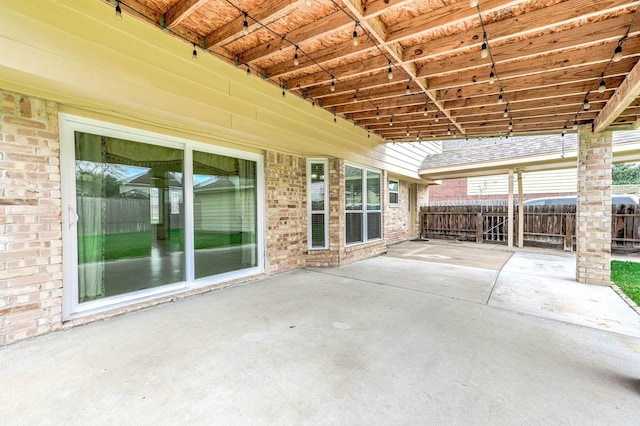 view of patio featuring fence