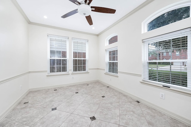 empty room featuring baseboards, ornamental molding, and tile patterned flooring