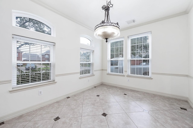 unfurnished dining area with baseboards, ornamental molding, visible vents, and tile patterned floors