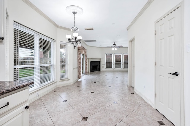 unfurnished living room with ornamental molding, visible vents, a fireplace, and light tile patterned floors