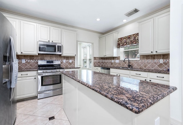 kitchen featuring light tile patterned floors, visible vents, appliances with stainless steel finishes, and backsplash