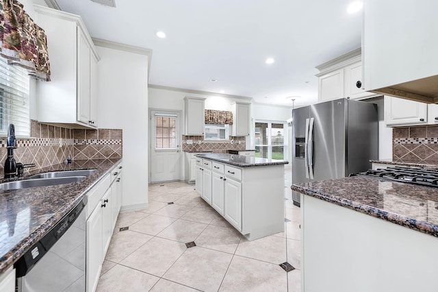 kitchen featuring light tile patterned floors, stainless steel appliances, a sink, and decorative backsplash