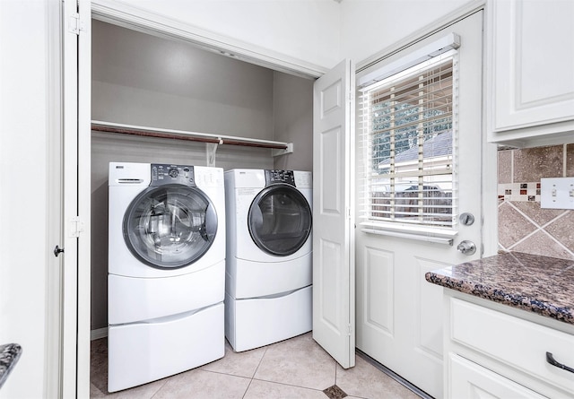 washroom with laundry area, washer and clothes dryer, and light tile patterned flooring