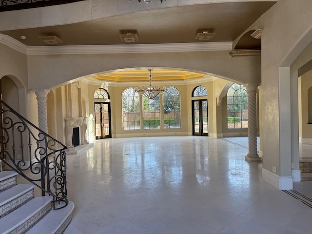 11117 Beinhorn Rd, Houston, TX 77024 - foyer entrance with crown molding, a fireplace, a chandelier, baseboards, and ornate columns