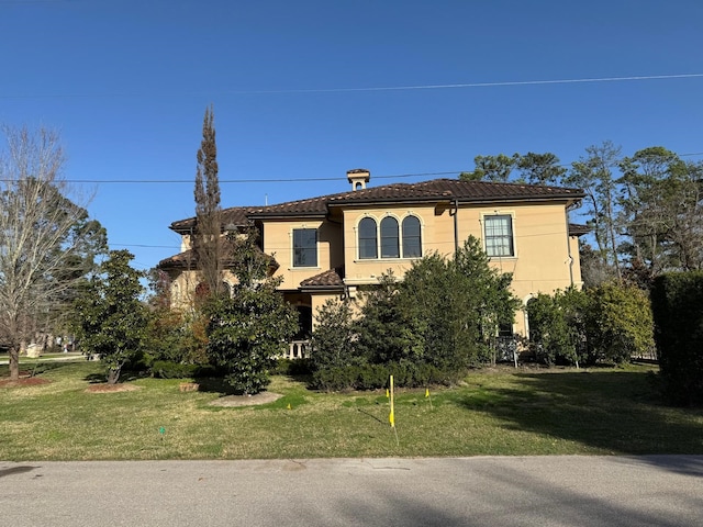 11117 Beinhorn Rd, Houston, TX 77024 - mediterranean / spanish-style home with a front yard, a tiled roof, and stucco siding