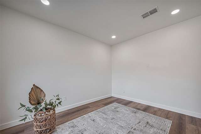 unfurnished room with recessed lighting, wood finished floors, visible vents, and baseboards