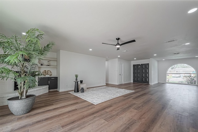 unfurnished living room with a ceiling fan, wood finished floors, visible vents, and recessed lighting